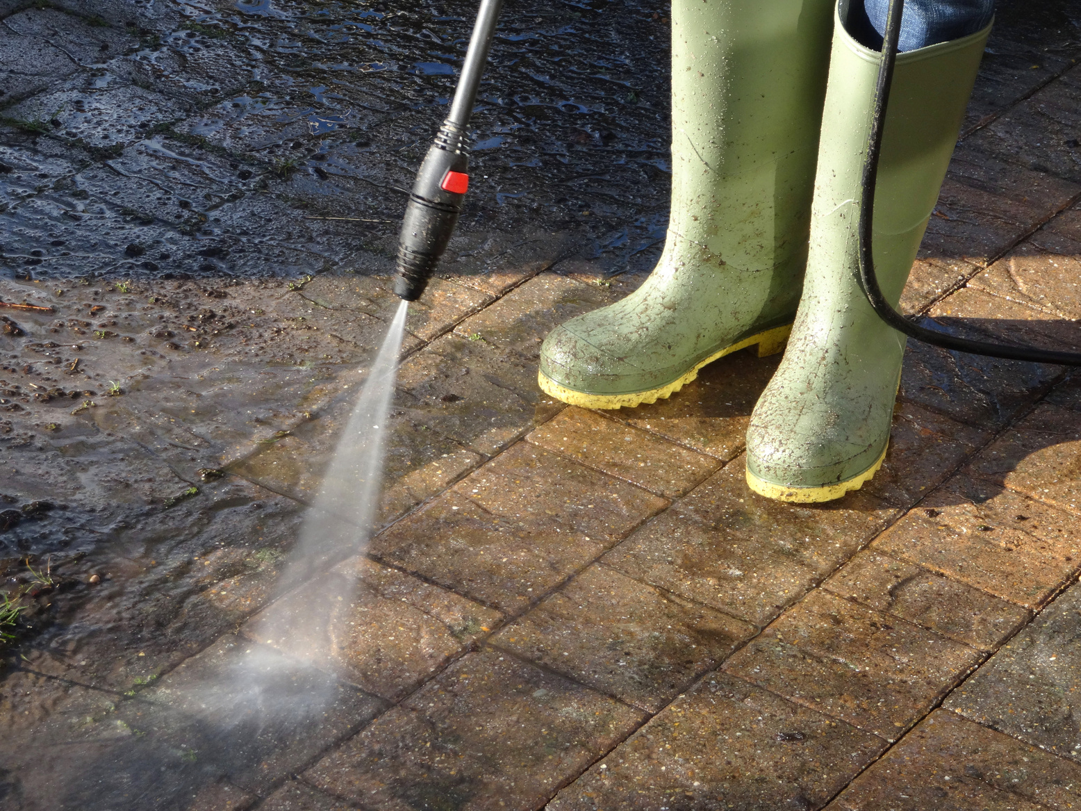 Image of boy washing driveway with pressurised powerwasher / pressure-washer nozzle